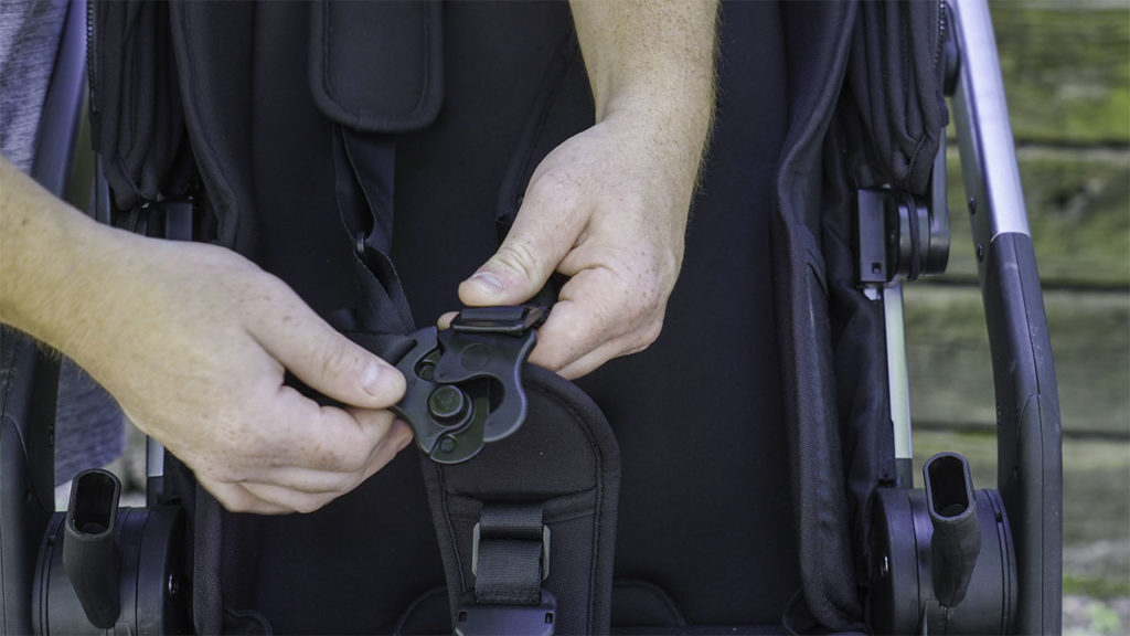 Person fastening the Colugo Complete buckles