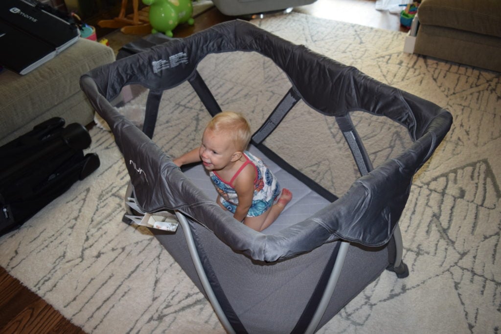 A toddler in a graphite Nuna Sena Aire