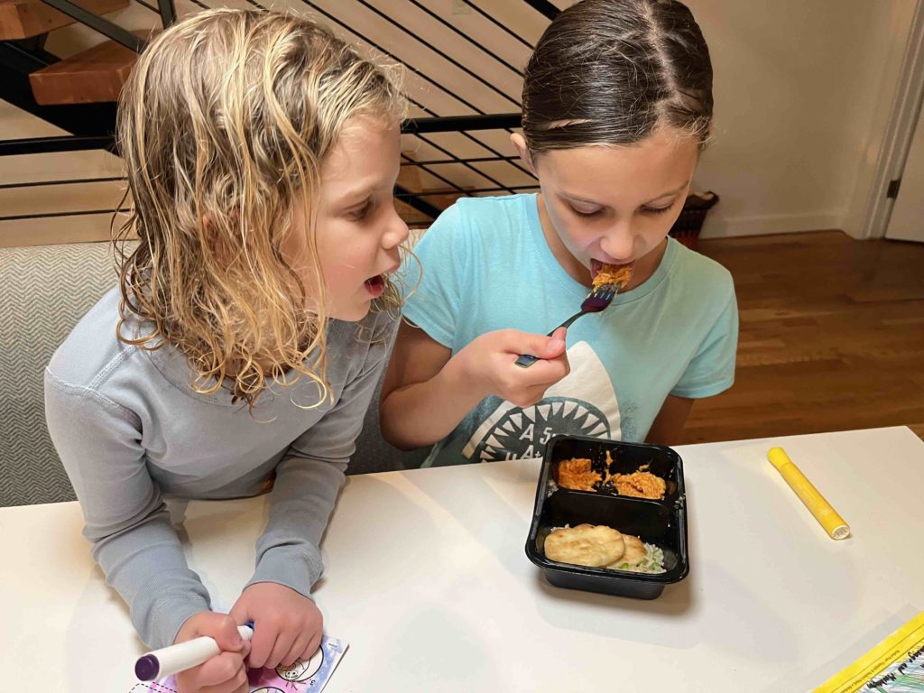 A kid eating butter chicken from Nurture Life