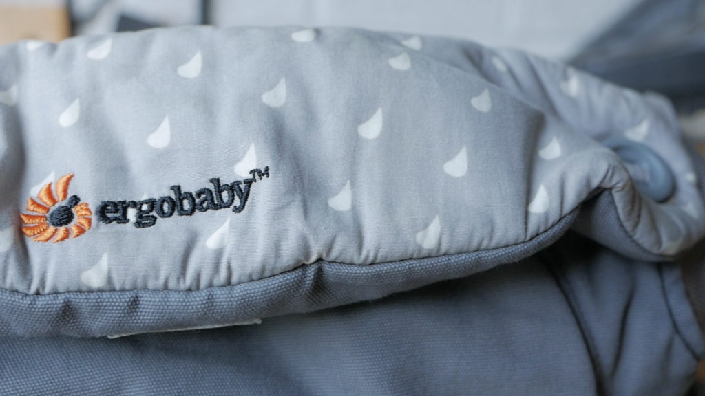 A closeup of the Ergobaby logo on an Ergobaby 360 baby carrier