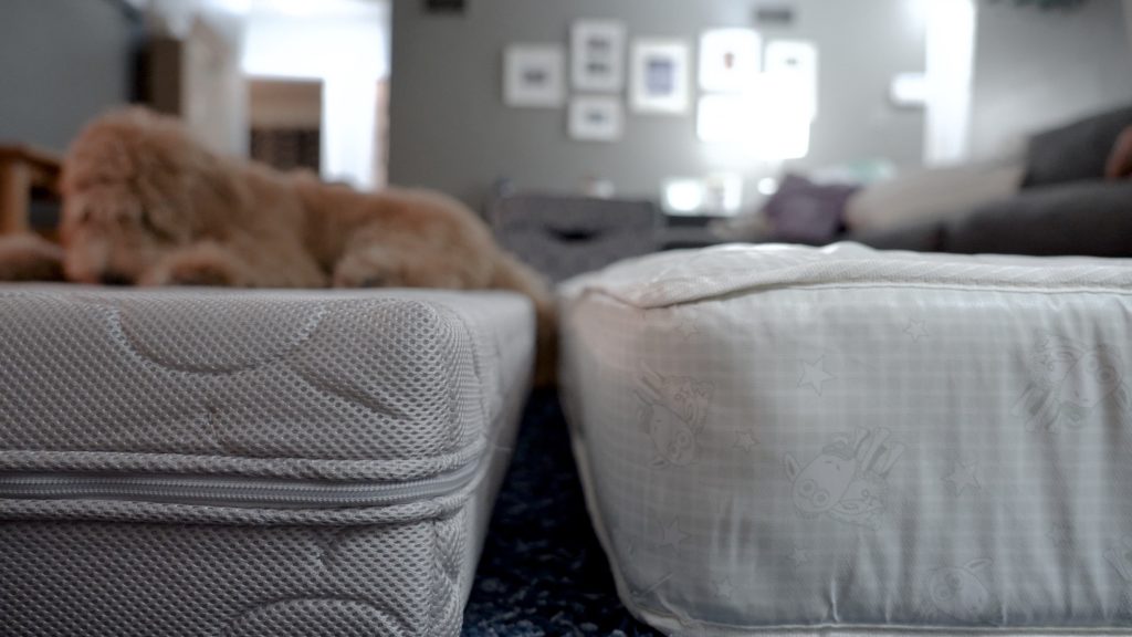 A Newton crib mattress next to a different crib mattress